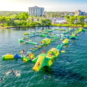 a small boat in a body of water with a city in the background