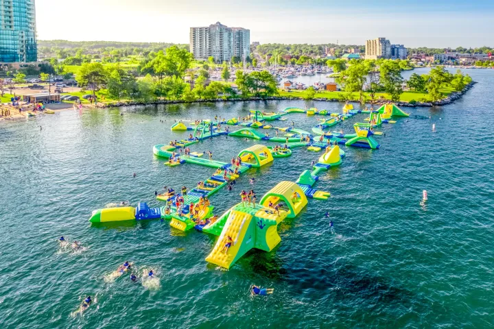 a small boat in a body of water with a city in the background
