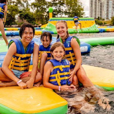 a group of people sitting on a raft in a pool